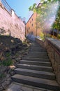 Ancient narrow stairs in Cesky Krumlov at sunny day.