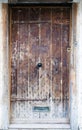 An ancient oak wood door with ornate metal handle Royalty Free Stock Photo