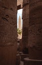 Ancient Obelisk through Stone Columns at Karnak Temple, Luxor Egypt Royalty Free Stock Photo