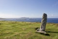 Ancient ogham stone monument on Dunmore Head in Dingle, Ireland, with blue sky in the background Royalty Free Stock Photo