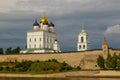 Ancient old fortress on the river bank bright clouds sky July 30rd 2016, Russia - Pskov Kremlin wall, Trinity Cathedral, Bell Towe Royalty Free Stock Photo