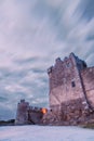 Ancient old Fortress Ross Castle with a lake, green grass and orange clouds. Killarney national park, co Kerry, Ireland