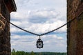 Ancient old lantern suspended on old iron chain between stone walls of Vyborg Castle against the cloudy sky, Vyborg Royalty Free Stock Photo