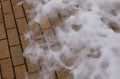 Ancient old yellow stone road covered with wet winter snow background Royalty Free Stock Photo