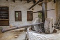 Ancient olive oil production machinery, stone mill and mechanical press, oil mill for olives. Abandoned old grinding stone in Mani