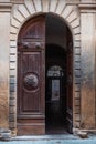 An ancient open wooden door with a chair at the end of the hall Royalty Free Stock Photo