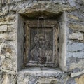 Ancient orthodox wood Jesus Christ icon in stone wall of old church