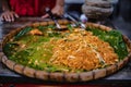 Ancient Pad Thai put on a pan lined with banana leaves for sale at Ban Chak Ngaew Chinese Community Market