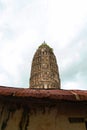 Ancient pagoda behind zinc roof in Thai buddhist temple