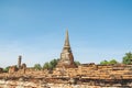 An ancient pagoda in an old temple and a very old brick wall in Ayutthaya, Thailand