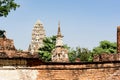 An ancient pagoda in an old temple and a very old brick wall in Ayutthaya, Thailand