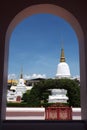 Ancient pagodas in an old temple with round arch foreground.