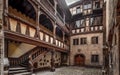 Ancient patio with wooden staircase in old timber-framing rich house XV century Royalty Free Stock Photo