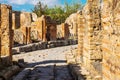 Ancient paved street is recovered in the middle of Roman ruins in Pompeii, Italy Royalty Free Stock Photo