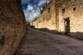 Ancient paved street is recovered in the middle of Roman ruins in Pompeii, Italy Royalty Free Stock Photo