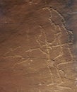 An ancient petroglyph of  hunter with bow and  silhouette of  running animal Royalty Free Stock Photo