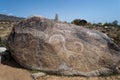 Ancient petroglyph - Hunting with tame snow leopards on the stone Royalty Free Stock Photo