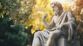 Ancient philosopher statue sitting in sunny park Royalty Free Stock Photo