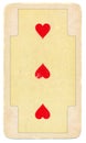Ancient playing card with three red hearts