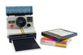 Ancient Polaroid instant photo camera with flash and photo pack in front of a white background in Dieren, The Netherlands