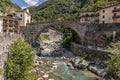 The ancient Pont Saint Martin bridge, in the historic center of the homonymous village, on a sunny day, Aosta Valley, Italy