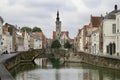 Ancient Poortersloge bridge over the canal surrounded by traditional buildings.