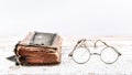 Ancient prayer book with old spectacles on the wooden table, view at an angle, banner with space for text Royalty Free Stock Photo