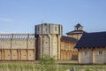 Ancient reconstruction of a wooden fortress with high walls and towers Royalty Free Stock Photo