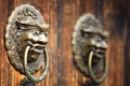 Ancient red doors with gilded studs and lion head door knockers closeup Royalty Free Stock Photo