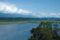 An ancient relict lake in Pitsunda. Mountains covered with snow in the background. Huge white clouds hang over the