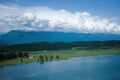 View of the mountains and the ancient lake. The peaks of the mountains are covered with snow. Lake Inkit in Abkhazia.