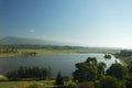 An ancient relict lake in Pitsunda, surrounded by cypresses and eucalyptus trees. Beyond the lake are mountains