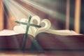 Ancient religious book and wooden cross on the background of a wooden