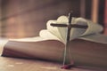 Ancient religious book and wooden cross on the background of a wooden