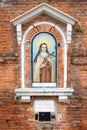 Religious mosaic on a narrow street in Venice, Italy