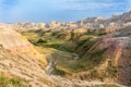 An ancient river bed runs through the eroded, yellow hills of Badlands National Park. Royalty Free Stock Photo