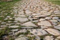 Ancient road paved with cobblestone. Closeup. Royalty Free Stock Photo