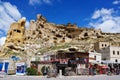 Ancient rock castle in Cavusin village near Goreme and many souvenir shops nearby