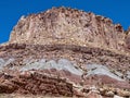 Ancient rock formations tower above the abandoned Oyler Uranium Mine entrance at Capitol Reef National Park, Utah, USA Royalty Free Stock Photo