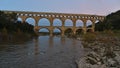 Ancient Roman aqueduct Pont du Gard crossing Gardon river after sunset near Vers-Pont-du-Gard, Occitanie, France. Royalty Free Stock Photo