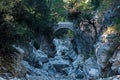Ancient Roman bridge over a shady gorge in the Kesme Bogazi canyon, Turkey Royalty Free Stock Photo