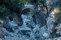 Ancient Roman bridge over a shady gorge in the Kesme Bogazi canyon, Turkey Royalty Free Stock Photo