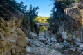 Ancient Roman bridge over a shady gorge in the Kesme Bogazi canyon, Turkey Royalty Free Stock Photo