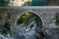 Ancient Roman bridge over a shady gorge in the Kesme Bogazi canyon, Turkey Royalty Free Stock Photo