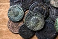 Ancient Roman coins with emperors portraits close-up, pile of old metal money on vintage background, top view. Concept of Rome, Royalty Free Stock Photo