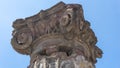 Ancient Roman column capital (head) with blue sky in the background in Pompeii. Pompei, Campania, Italy, July 2020. Royalty Free Stock Photo