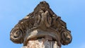 Ancient Roman column capital (head) with blue sky in the background in Pompeii. Pompei, Campania, Italy, July 2020. Royalty Free Stock Photo