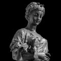 Ancient Roman or Greek neoclassical statue of young woman isolated on black background. Female sculpture