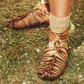 An ancient Roman man legs in caligae leather sandals. Reconstruction of the events of the Roman Empire