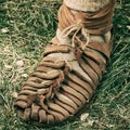 An ancient Roman man legs in caligae leather sandals. Reconstruction of the events of the Roman Empire